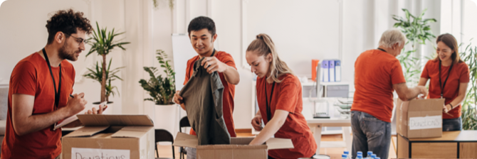 Photo of people folding clothes in a donation centre 