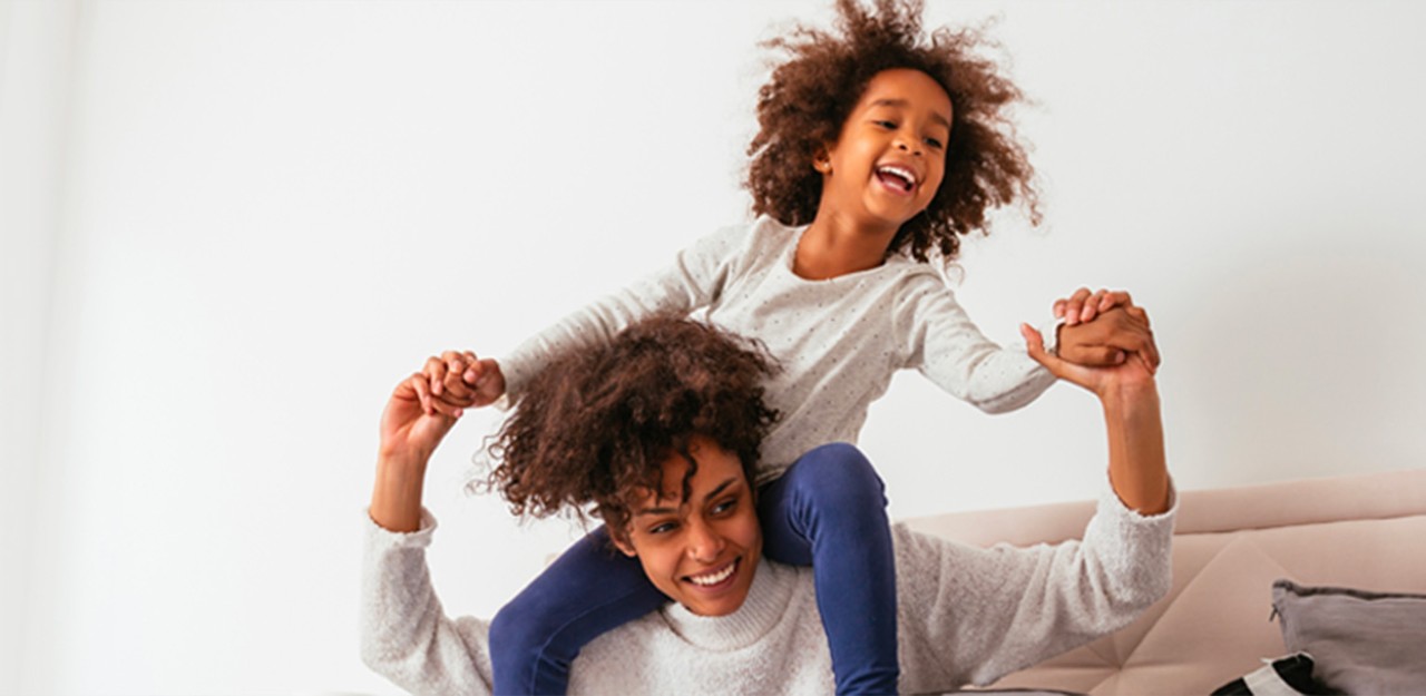 Photo of a woman and her baby smiling