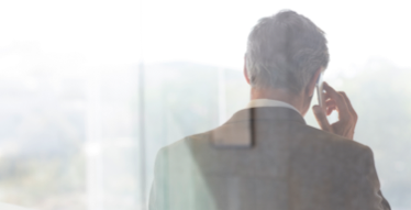 Photo of a man seen from behind talking on a mobile phone 