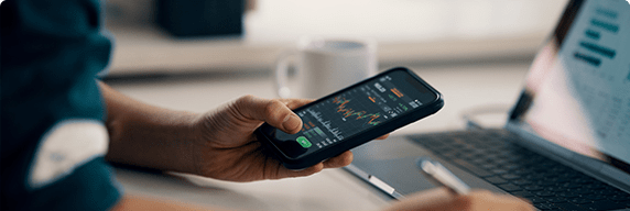 Photo of a person looking at a graph on their phone