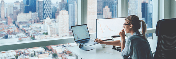 Photo of a woman in an office working on her laptop