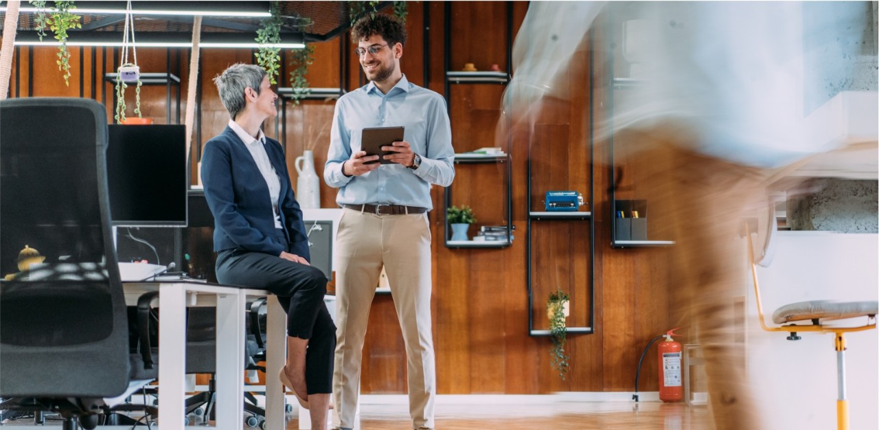 Photo of two businesspeople talking in an office
