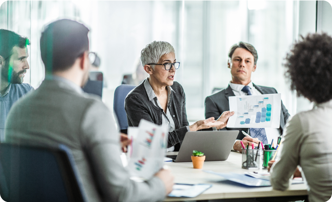 Photo of a group of people talking in a conference room