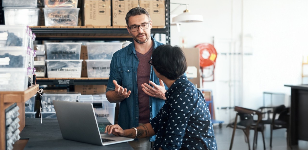 Photo of two people talking in a warehouse 