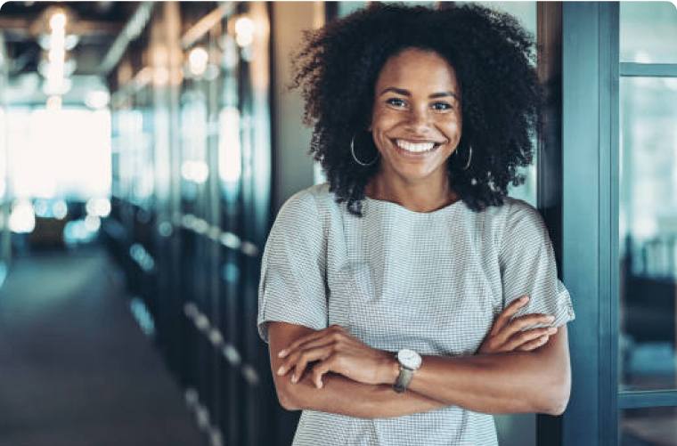 Photo of a person smiling in the hallway of an office