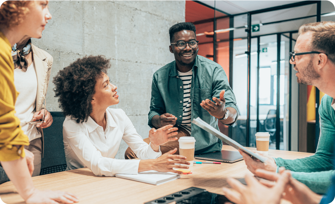 Photo of a group of people talking in a conference room