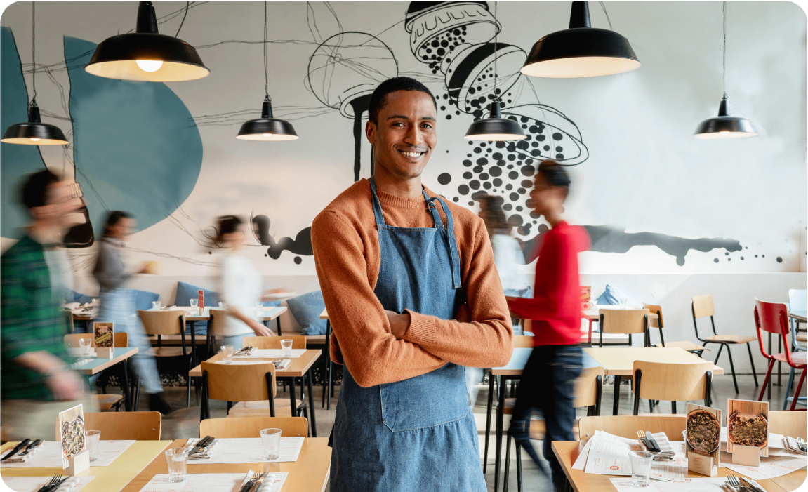 Photo of a business owner standing in their coffee shop
