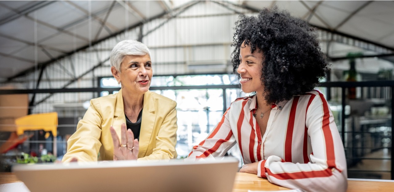 Photo of two people talking in a warehouse 