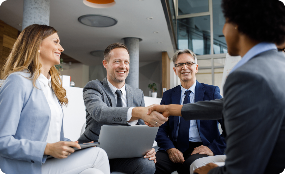 Photo of a group of people agreeing to a deal in an office building 