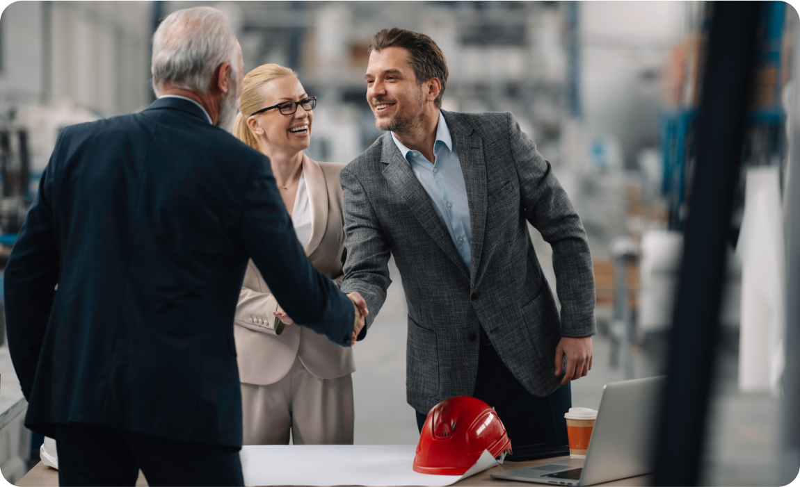 Photo of two people shaking hands in a warehouse 