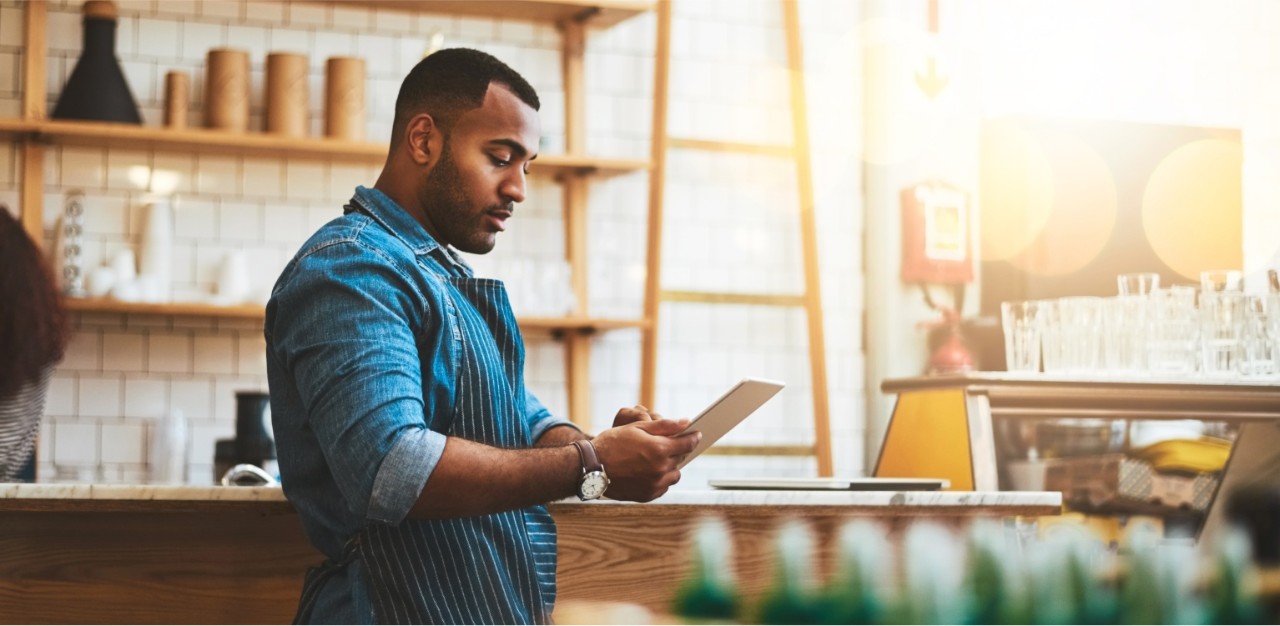 Photo of an entrepreneur using online banking business services on their tablet