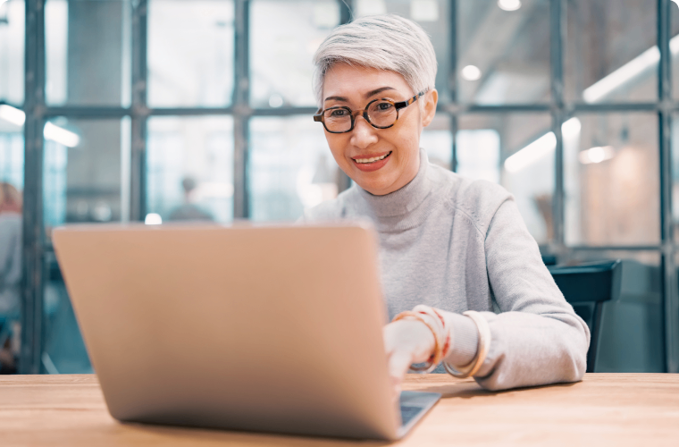 Photo of an entrepreneur on their computer watching demos for their online banking services