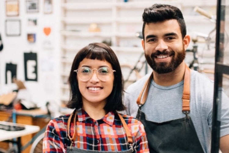 Picture of two smiling people in a workshop 