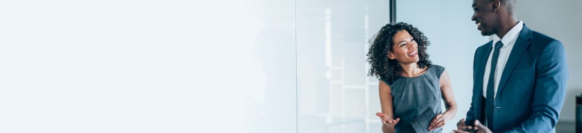 A man and woman discussing things in an office