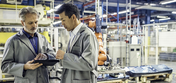 Two people talking in an industrial place