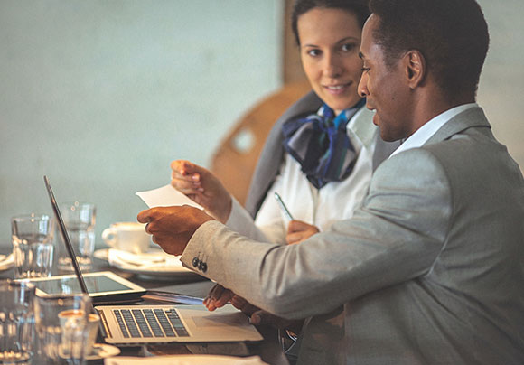 Man and woman with computer on the table