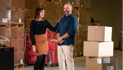 Photo of a National Bank advisor and their client in a warehouse filled with boxes 