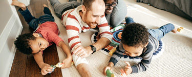 Young family playing in the living room