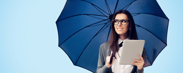 Photo of a young woman with a tablet in one hand and an open umbrella in the other
