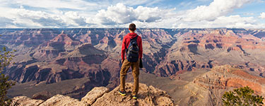 Man in front of a cliff