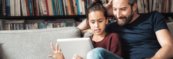 Man looking at tablet with his daughter