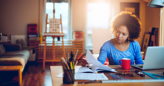 Female student sitting at her desk reading a document