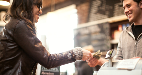 Woman giving money to cashier