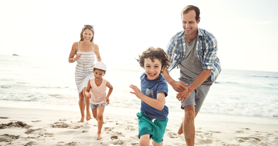 Family running on the beach
