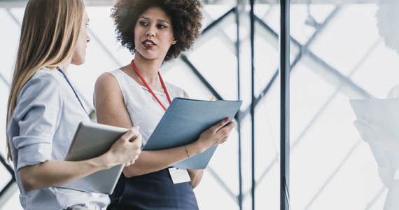 Two young professional women chatting together