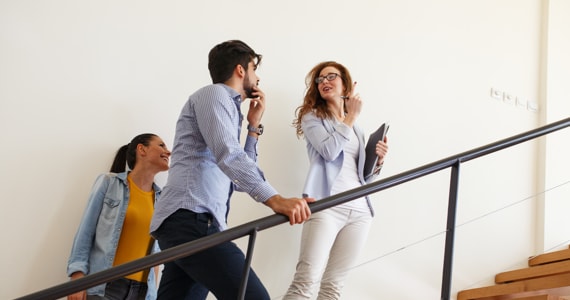 Young couple talking to an advisor on a staircase