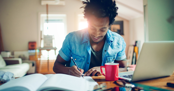 Young man studying with a smile