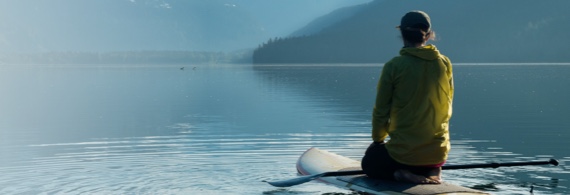 A person in a kayak on a water source.