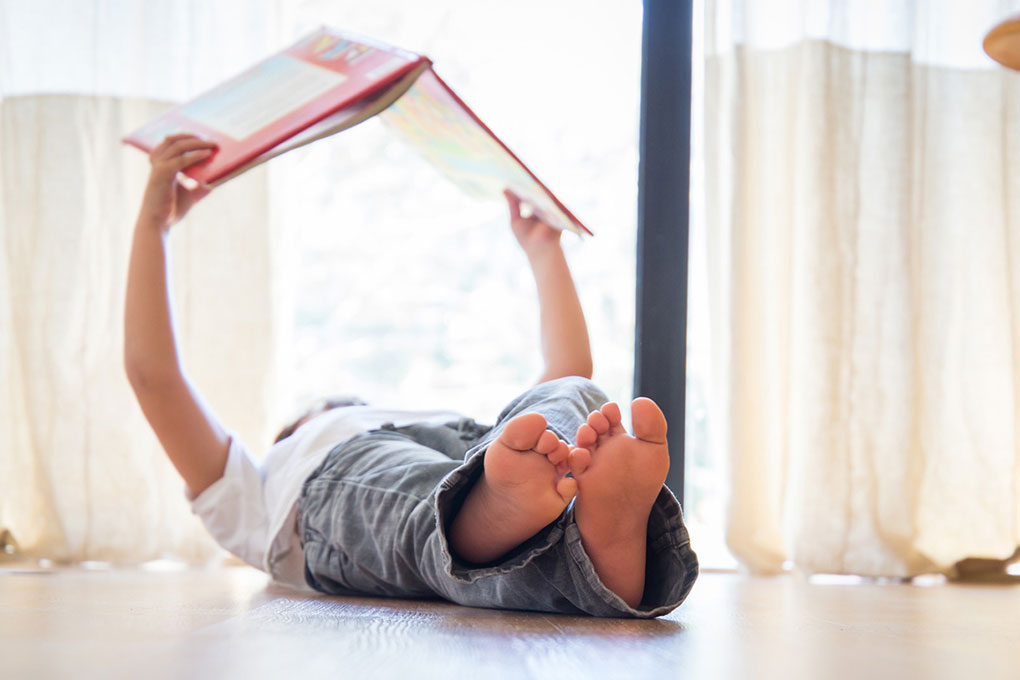 Person reading, laying on the floor