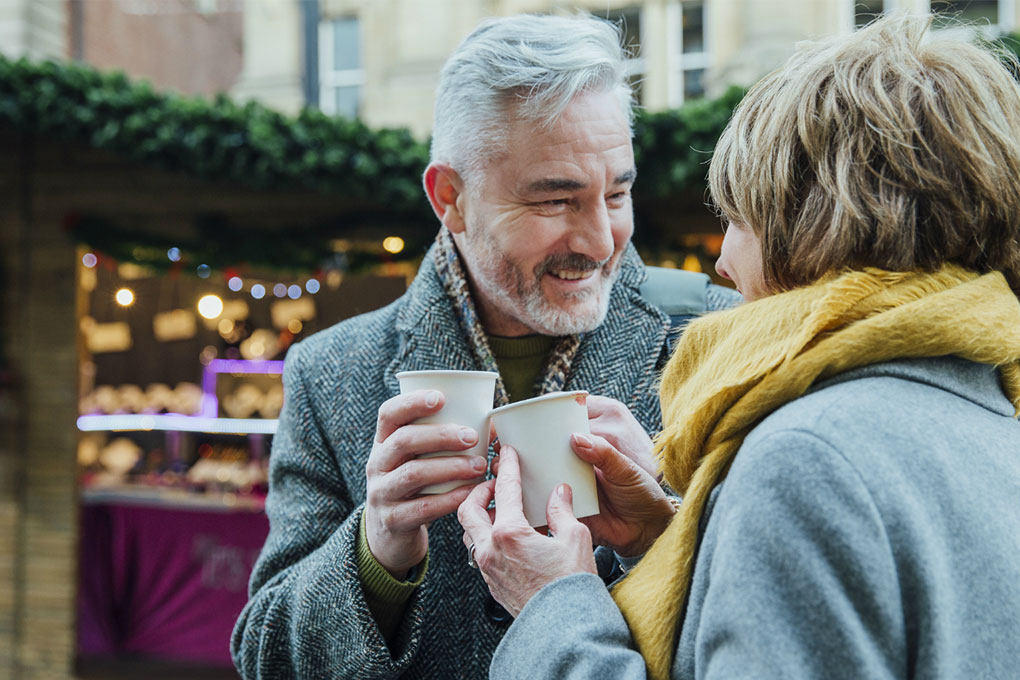 Couple discussing their CPP pension while drinking a coffee outside. 