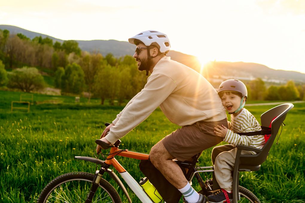 Dad with his son on a bike enjoying his savings 