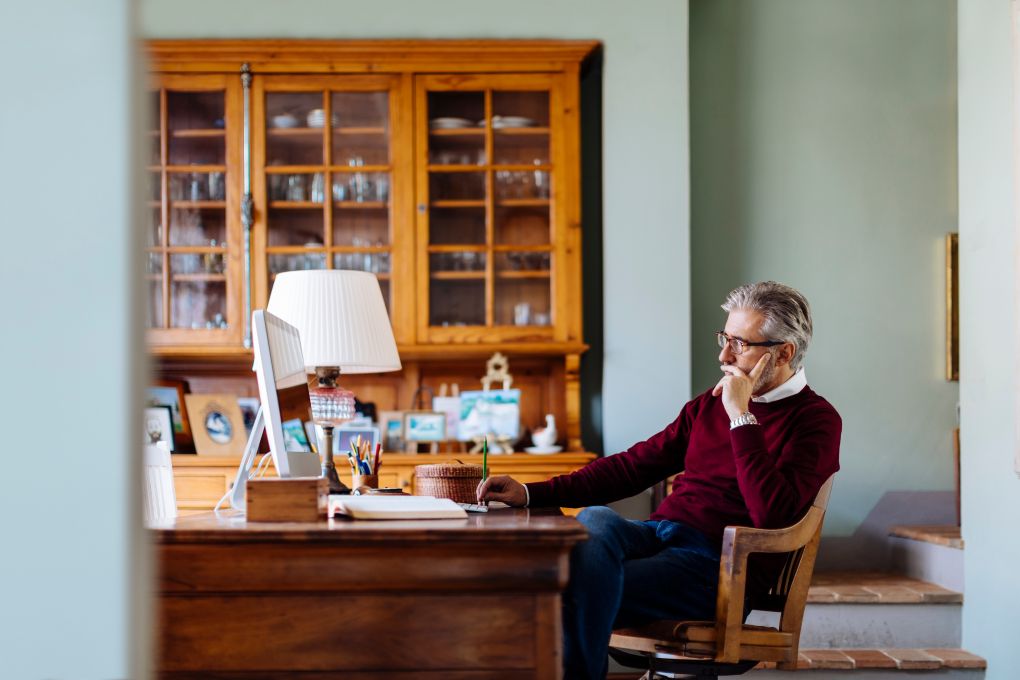 Man planning his retirement investments on his computer