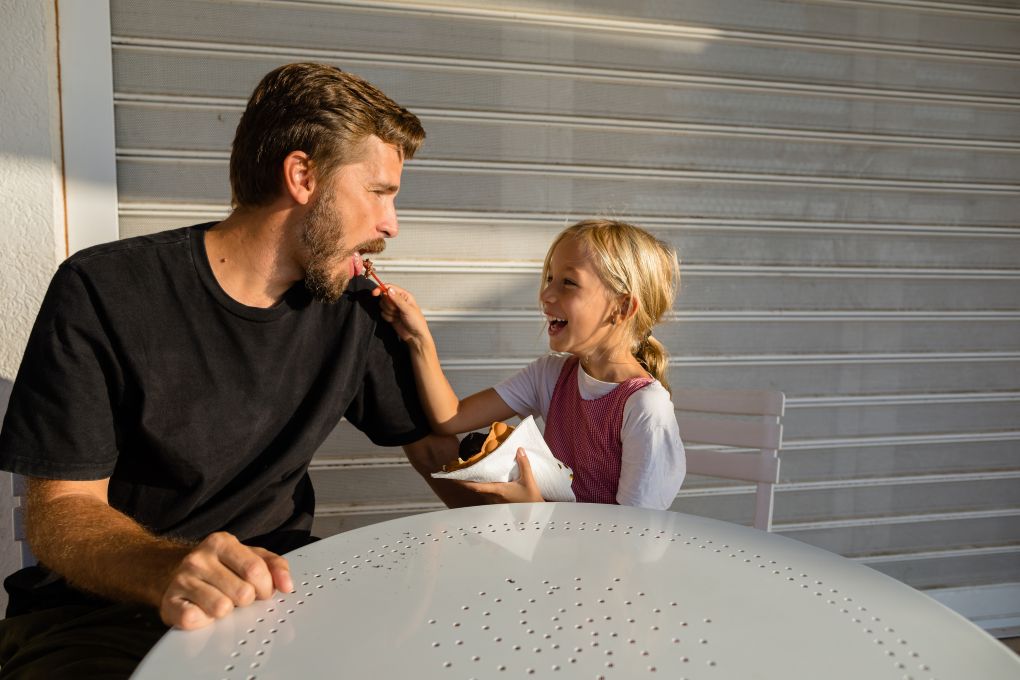 Father and daughter eating ice cream