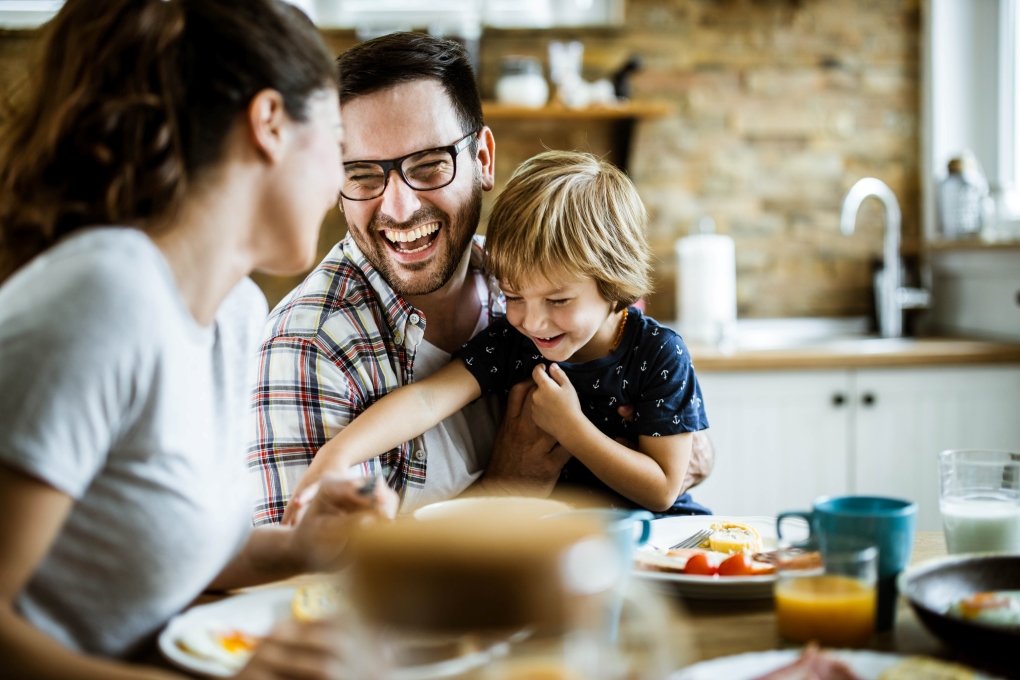 Image for an article on 40 tips to save money, showing a family having breakfast. 