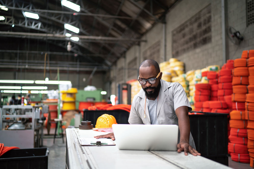 A man works on a laptop.