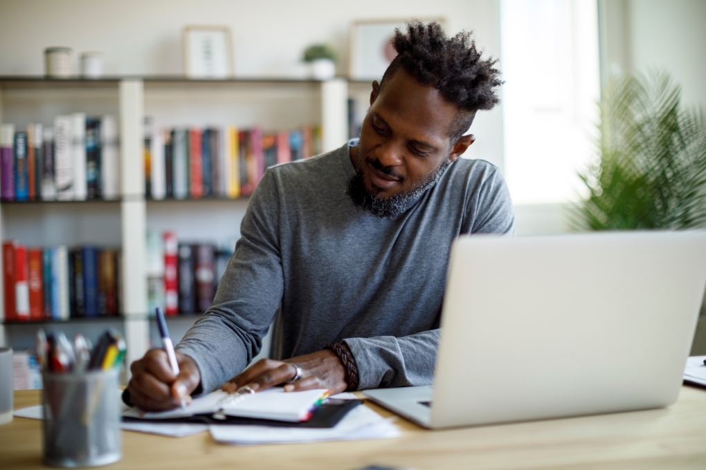 Image for the article on how to make a budget of a man at his desk doing his budget