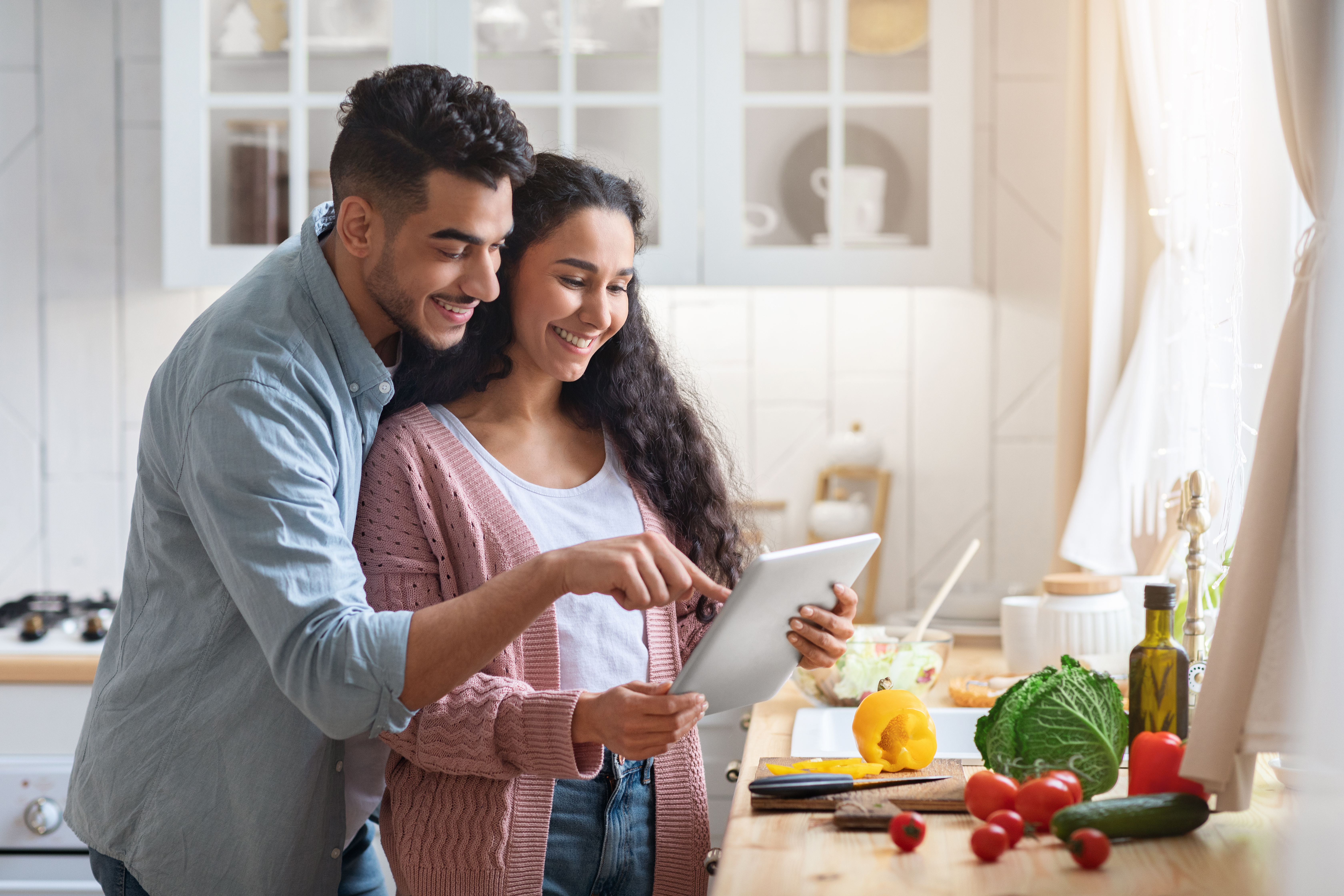 Couple opening a Canadian RRSP online using a tablet. 