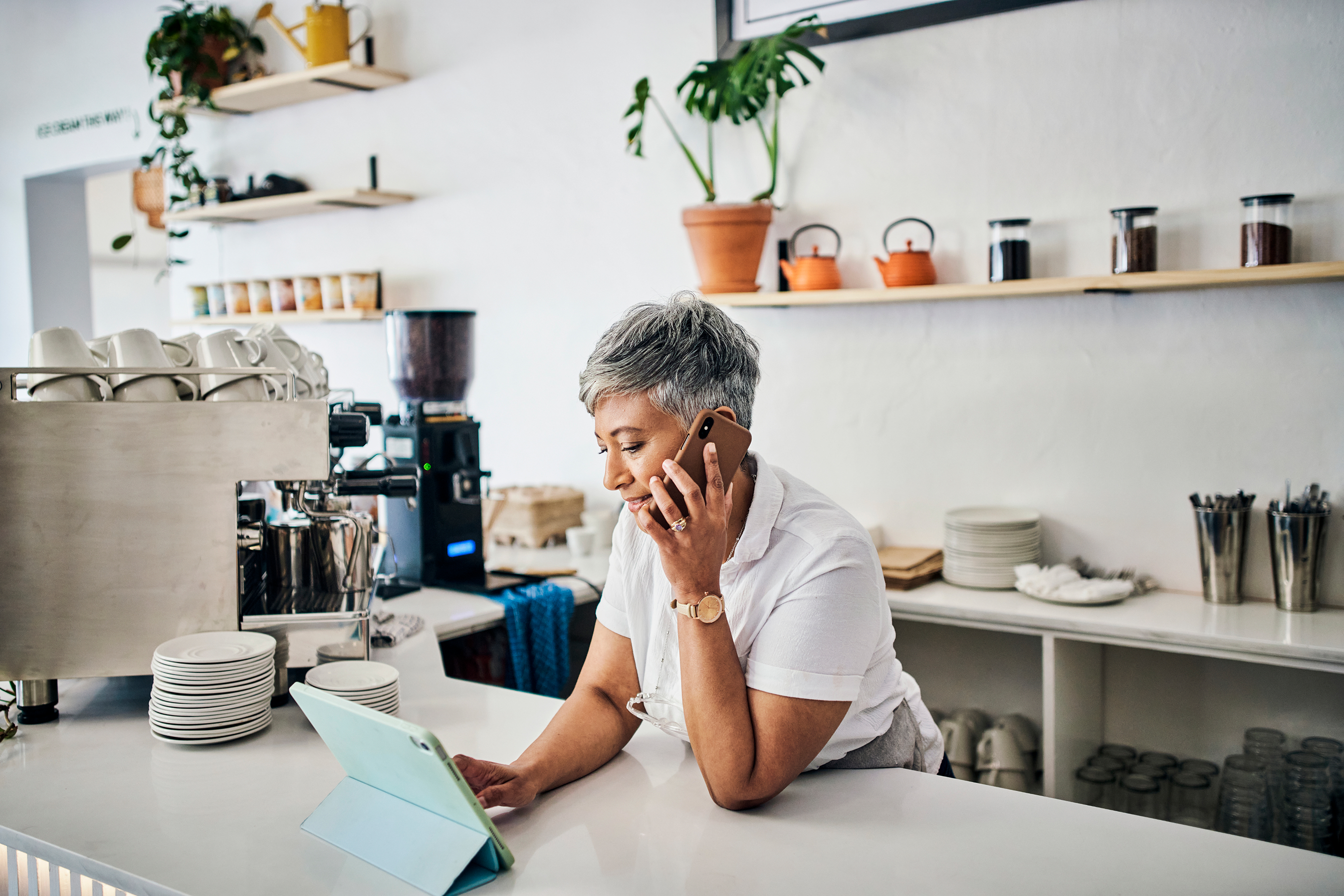 Senior female business owner talking on the phone 