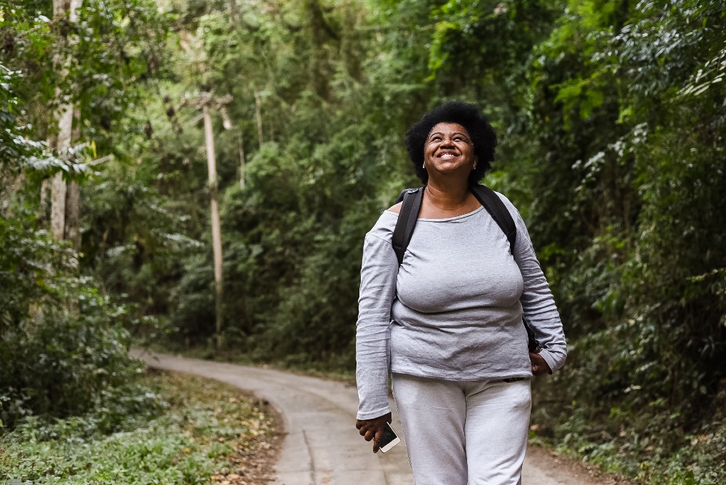 Image of a retired woman on a hike in nature