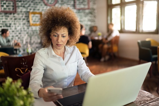 Woman learning at her computer to learn more about ISO 20022