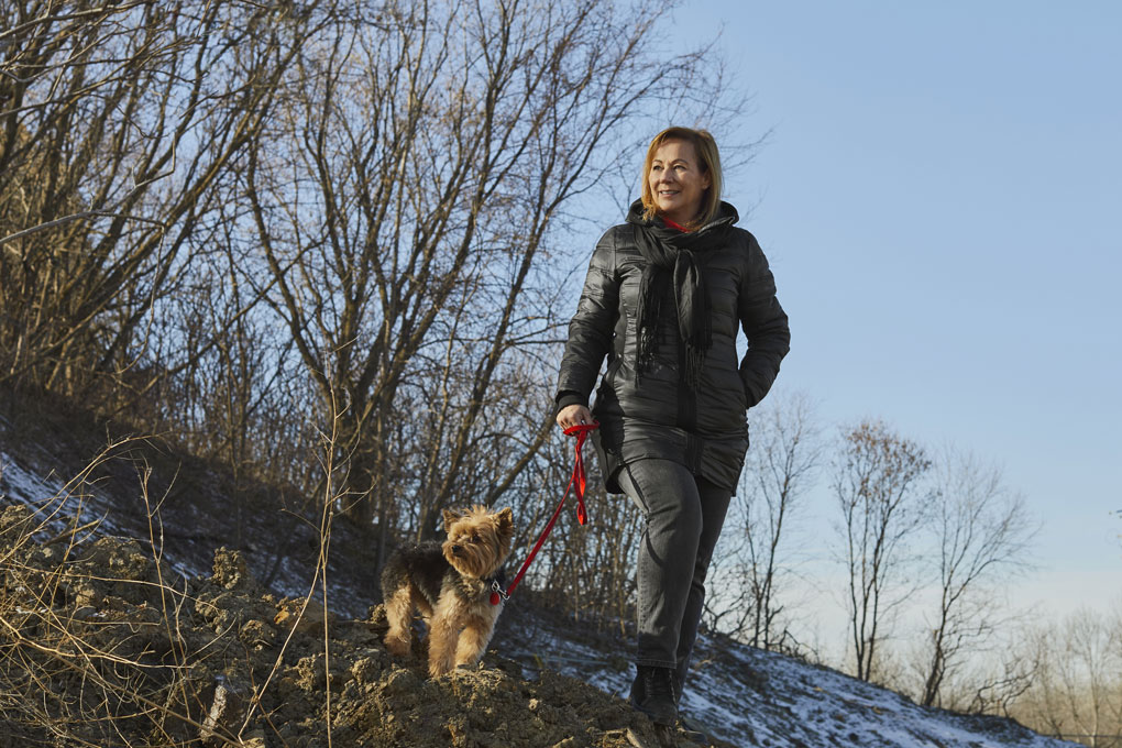 Photo of a woman walking with her dog