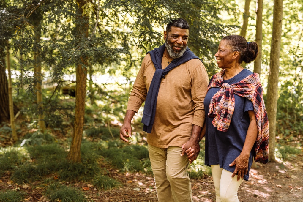 Retired couple walking in the woods Retired couple walking in the woods