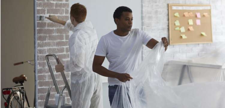 Photo of two people working on a home 