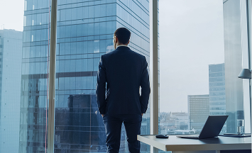 Photo of a person looking out a window