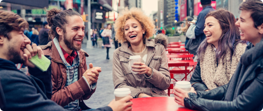 Photo of a group of friends laughing together on a terrace