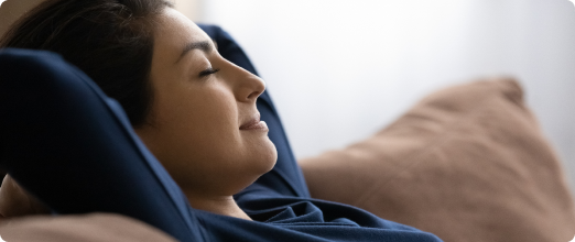 Photo of a woman relaxing on her couch 